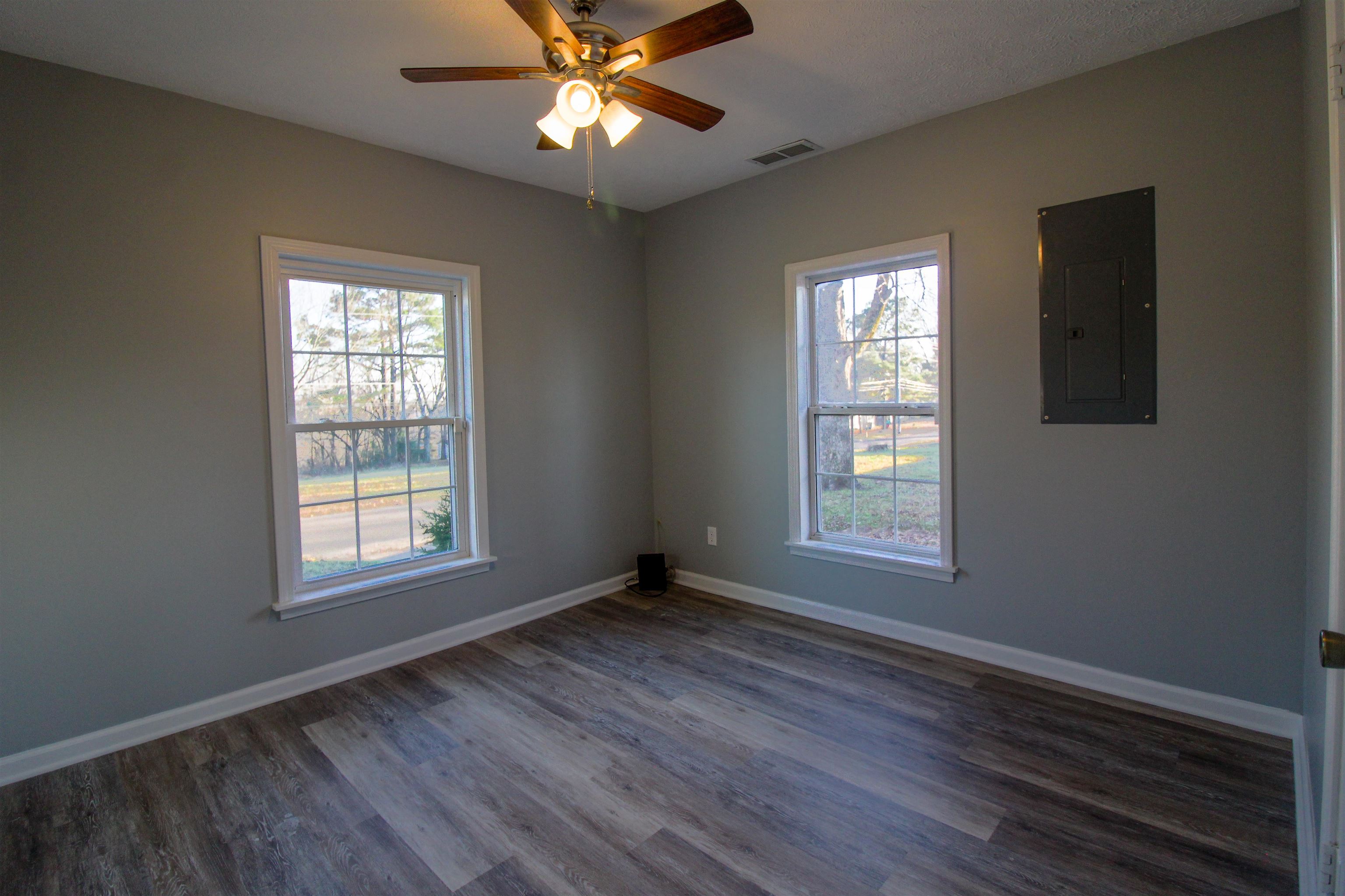 284 Highland Street Ripley, TN 38063 - Photo 9 of 25 a view of an empty room with wooden floor and a window