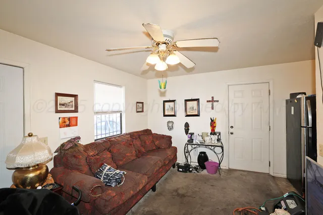 a bedroom with bed and a chandelier