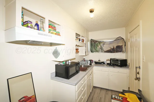 a kitchen with stainless steel appliances a stove a sink and a refrigerator