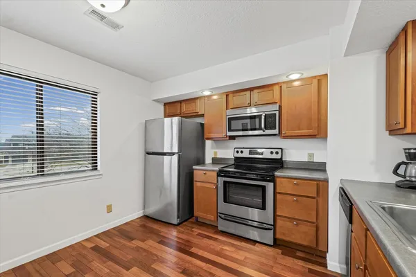 a kitchen with stainless steel appliances a stove microwave and refrigerator