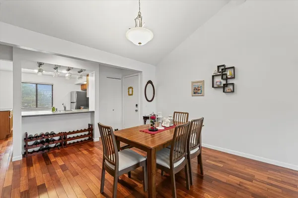 a dining room with furniture and wooden floor