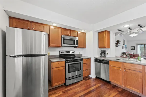 a kitchen with stainless steel appliances a refrigerator stove and sink