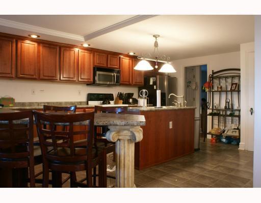 125 Leon Road Green Tree, PA 15220 - Photo 7 of 18 Kitchen. Cherry kitchen with center island, dining area with bar stools. Included appliances: microwave oven, electric stove, dishwasher, disposal refrigerator.