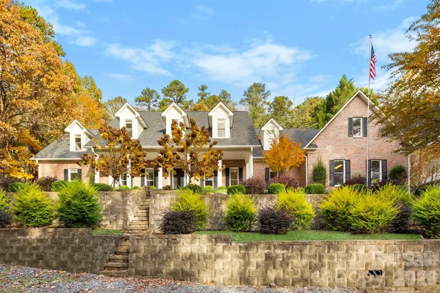 a view of a hallway with wooden floor and a chandelier