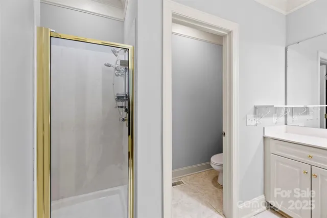 a view of an empty room with a ceiling fan