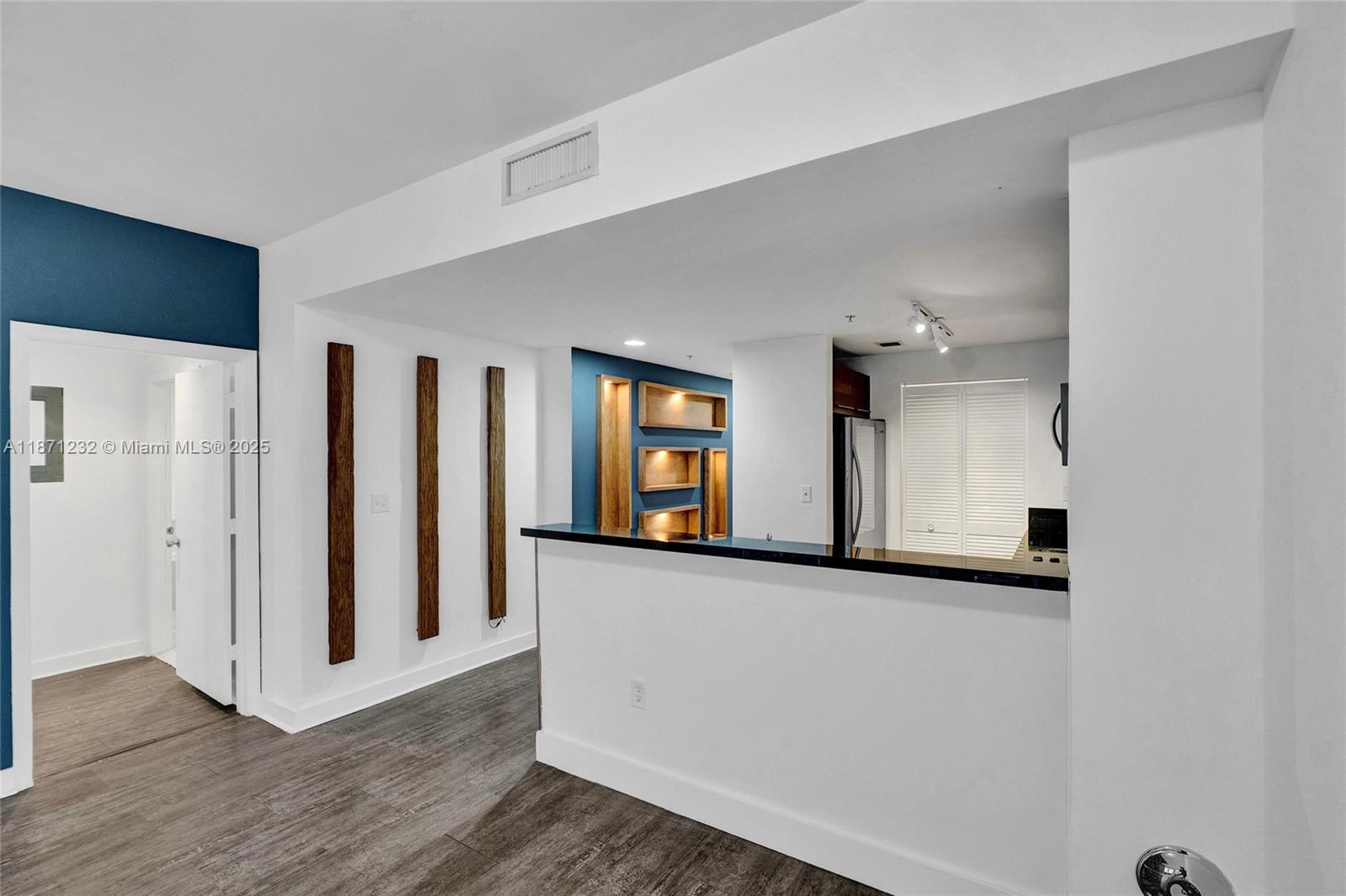 244 Biscayne Boulevard, Unit 406 Miami, FL 33132 - Photo 9 of 28 a view of a room with wooden floor and mirror