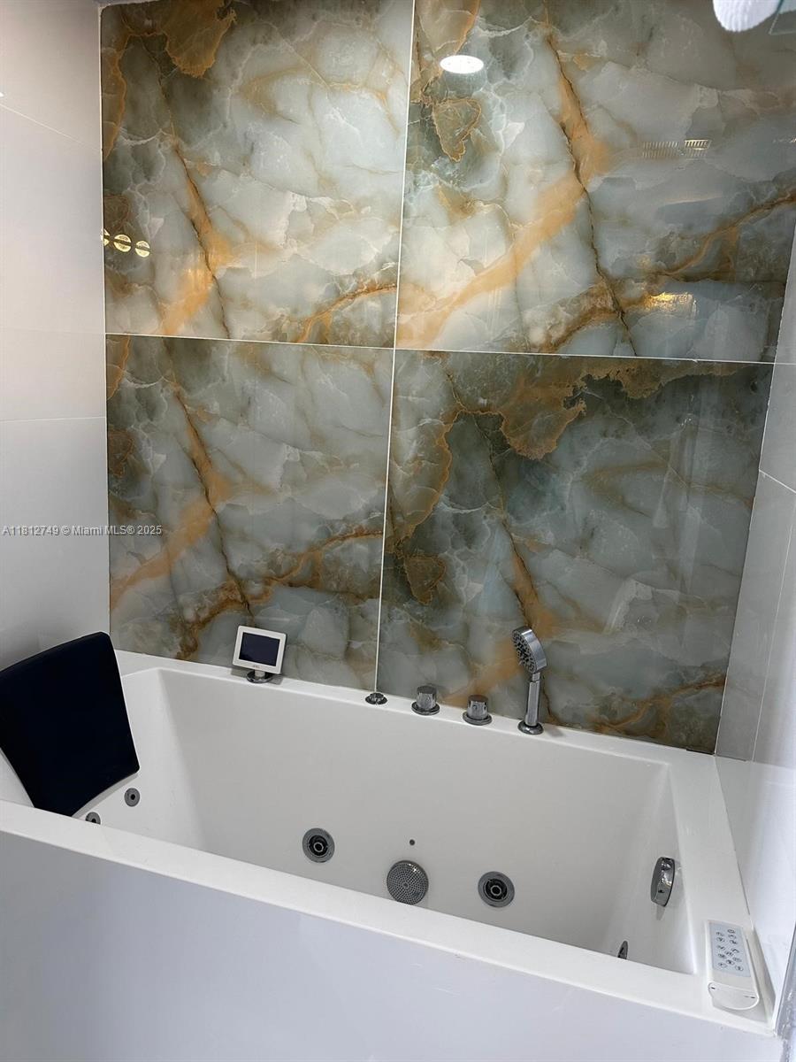 7601 East Treasure Drive, Unit 2022 North Bay Village, FL 33141 - Photo 13 of 16 a bathroom with a tub and a shower