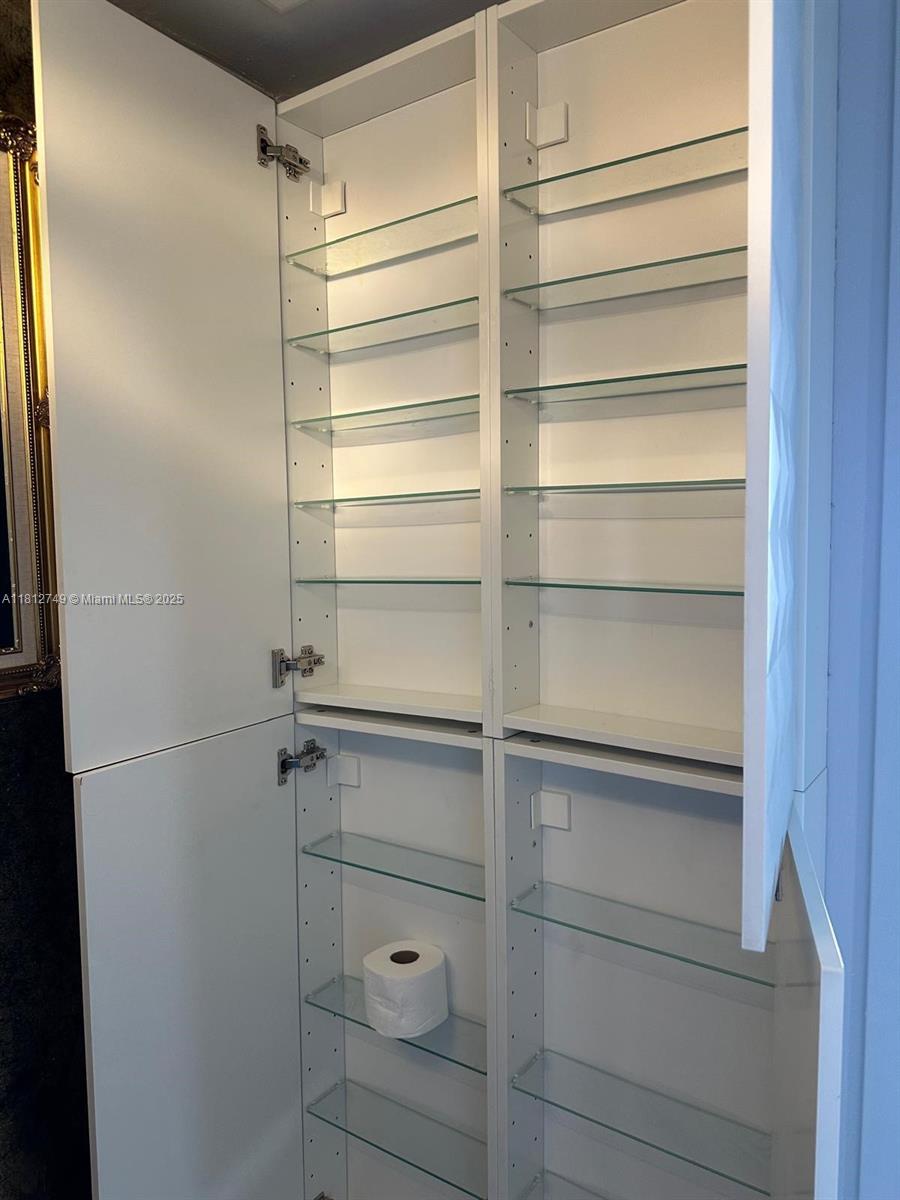 7601 East Treasure Drive, Unit 2022 North Bay Village, FL 33141 - Photo 14 of 16 a view of walk in closet with empty racks