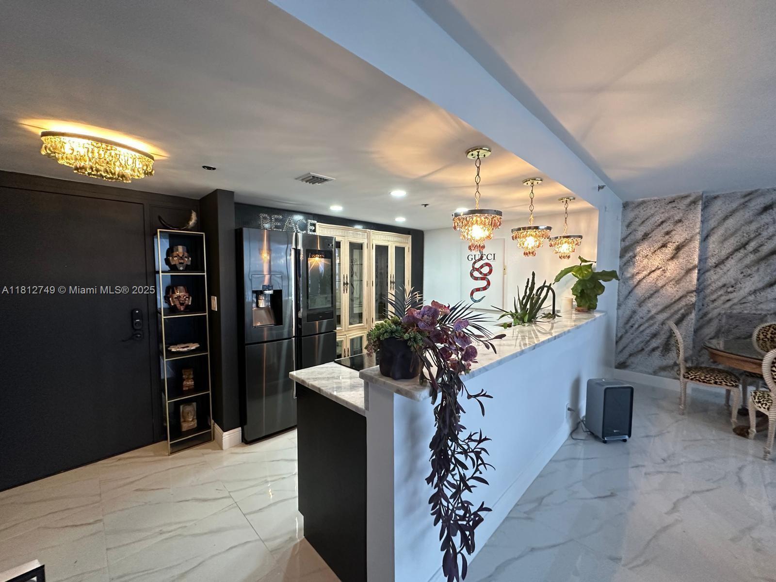 7601 East Treasure Drive, Unit 2022 North Bay Village, FL 33141 - Photo 2 of 16 a lobby with furniture and potted plants