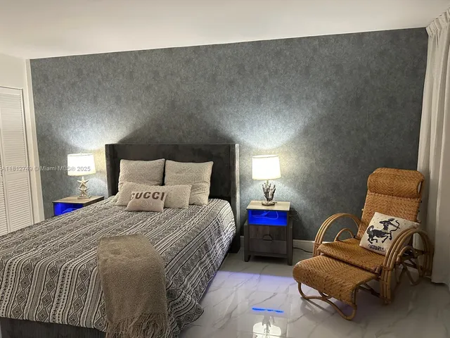 a bedroom with a bed chair and a couch