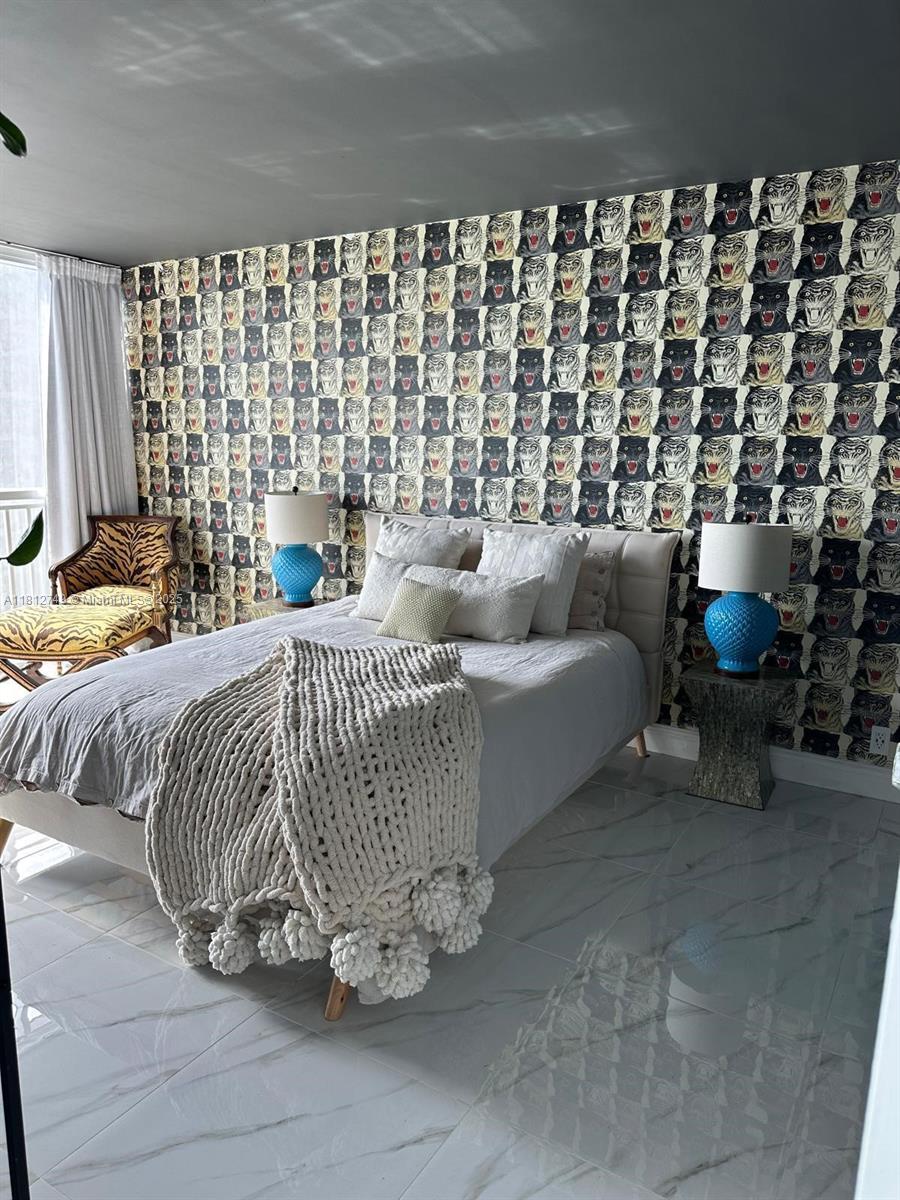 7601 East Treasure Drive, Unit 2022 North Bay Village, FL 33141 - Photo 4 of 16 a bedroom with a bed and a couch