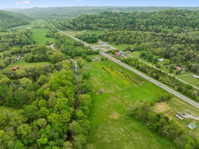 a view of a green field with lots of trees