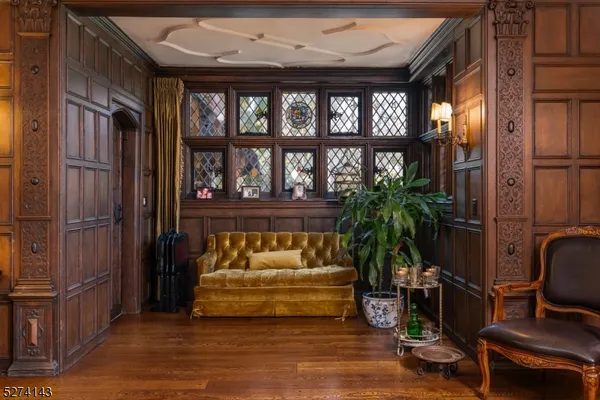 a living room with furniture fireplace and a large window