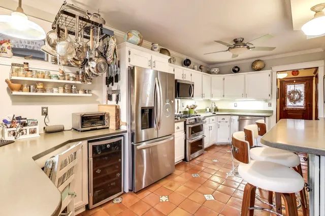 a kitchen with granite countertop a sink appliances cabinets and counter space
