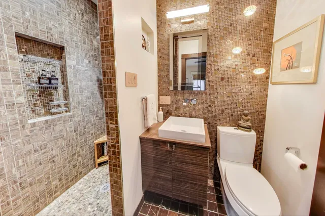 a bathroom with a toilet a sink and shower