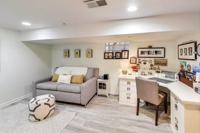 a living room with furniture and painting on the wall
