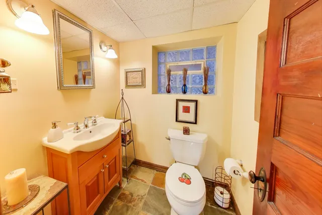 a bathroom with a sink mirror vanity and toilet