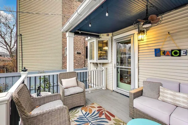 a balcony with furniture and a potted plant