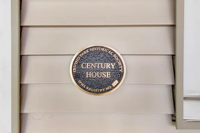view of a refrigerator with a white wall