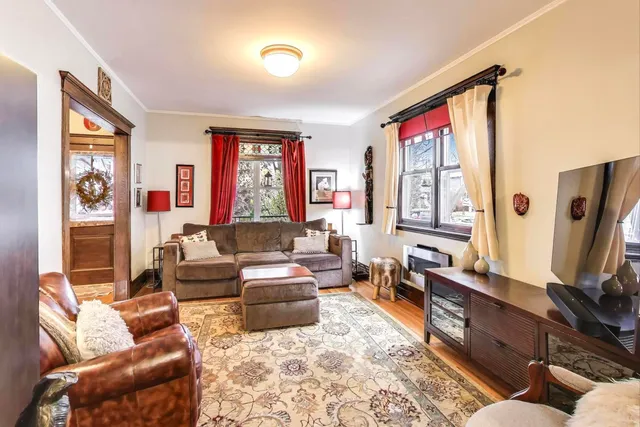 a living room with fireplace furniture and a flat screen tv