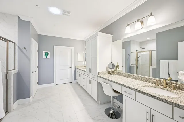 a bathroom with a double vanity sink a mirror and a shower