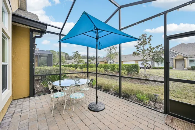 a view of a house with backyard and patio