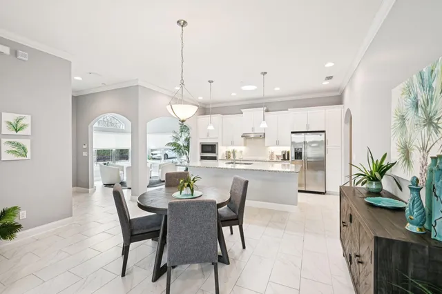 a dining room with furniture and a floor to ceiling window