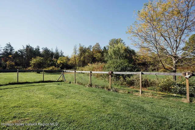 a view of yard with swimming pool and sitting area