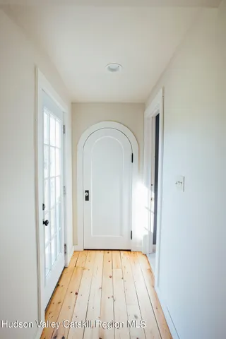 a view of an entryway with wooden floor