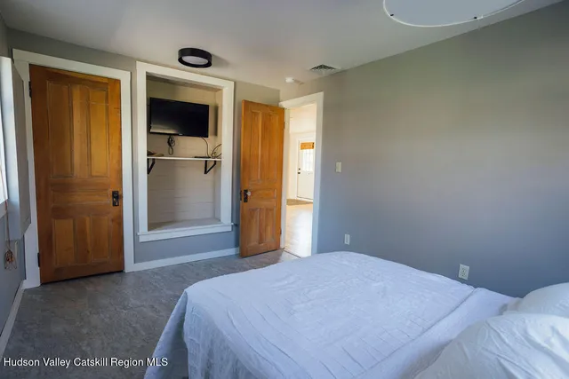 a bedroom with a bed and a bathroom