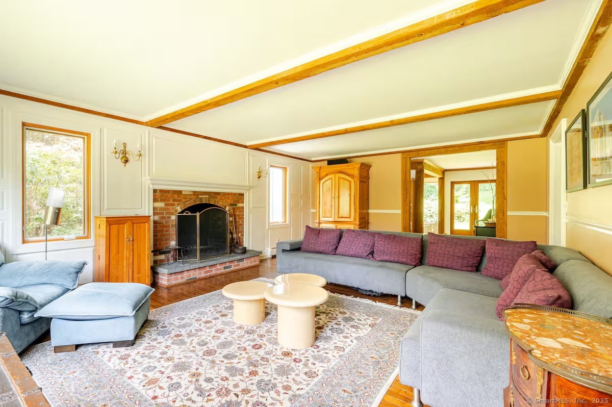 31 Cedar Hill Road New Milford, CT 06755 - Photo 12 of 40 a living room with furniture a fireplace and a table