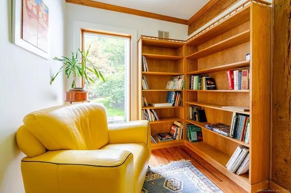 a living room with a couch and bookshelf