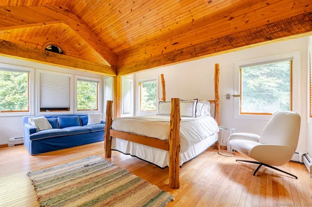 a bedroom with a bed and a couch