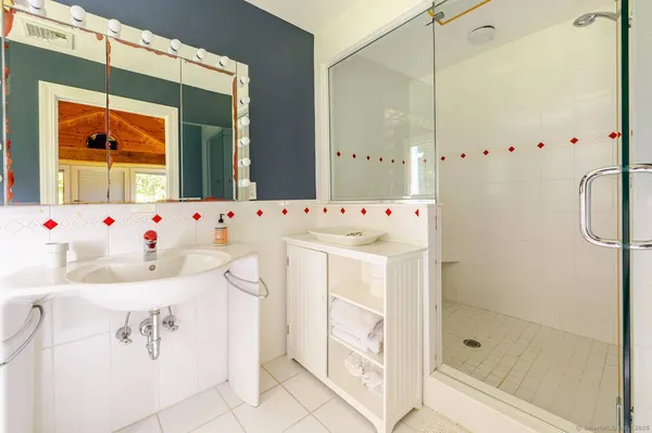 a bathroom with a window and white walls