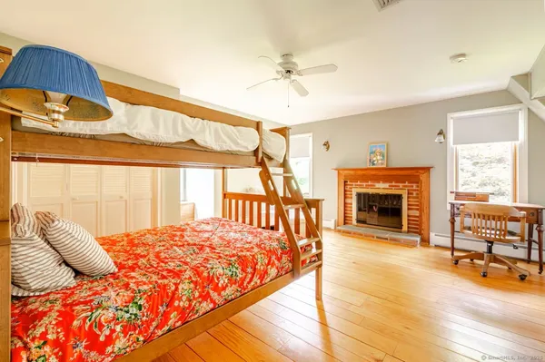 a bedroom with a bed and a fireplace