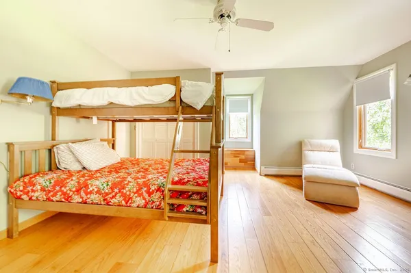 a bedroom with a bed and lamp on table