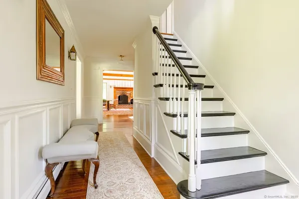 a view of entryway and hall with wooden floor