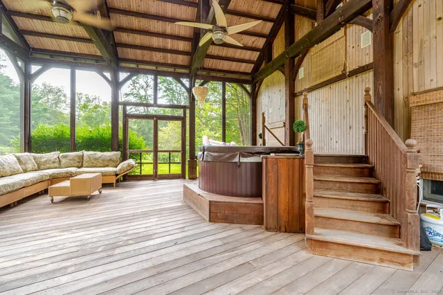 a living room with furniture and large windows