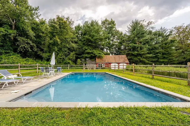 a view of a swimming pool with a yard