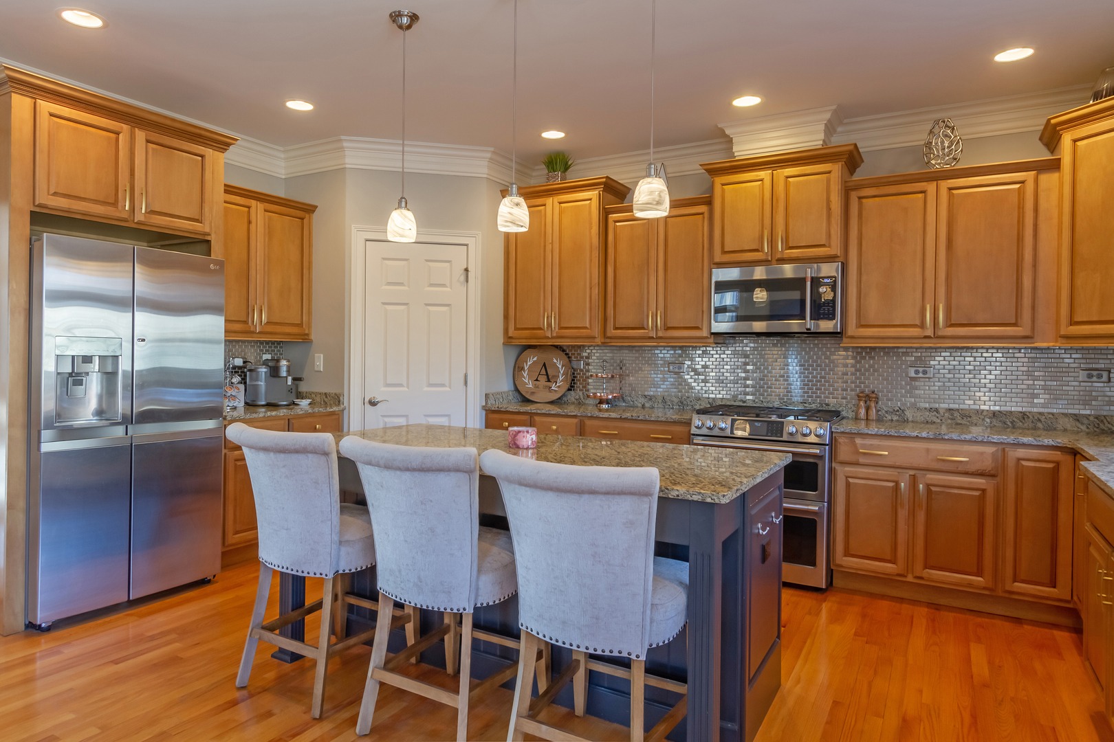 32 Bluestone Drive St. Charles, IL 60174 - Photo 13 of 33 a kitchen with stainless steel appliances granite countertop a sink a stove a refrigerator cabinets and chairs