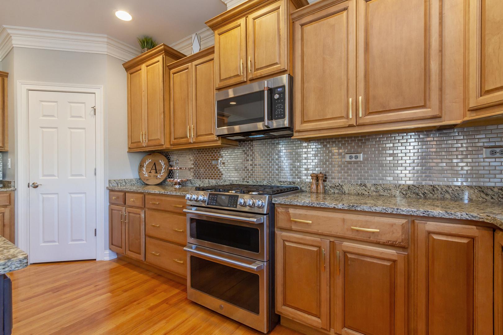 32 Bluestone Drive St. Charles, IL 60174 - Photo 15 of 33 a kitchen with stainless steel appliances granite countertop a stove a sink and a microwave