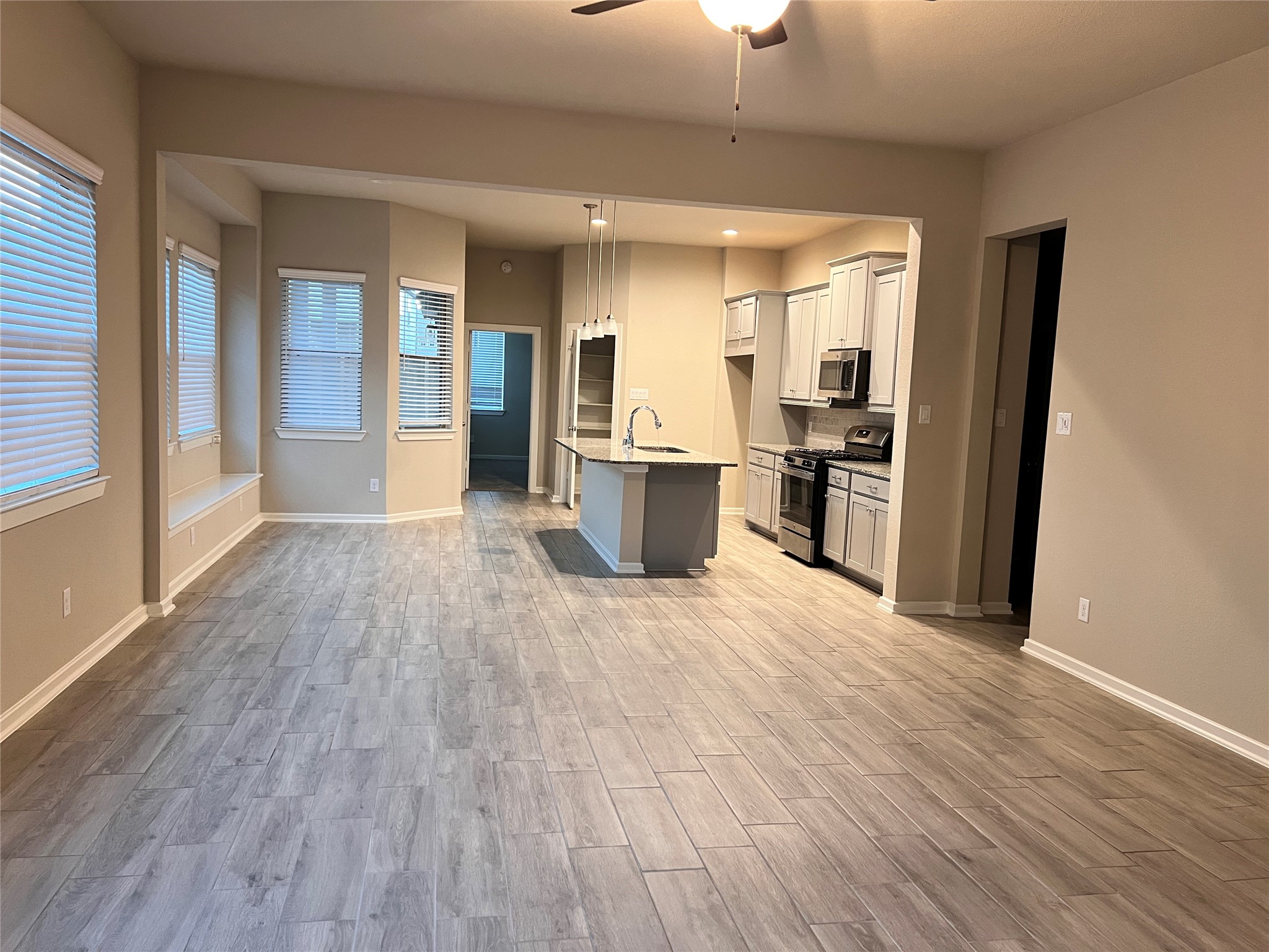 7912 Spring Run North Richland Hills, TX 76182 - Photo 13 of 21 an empty room with wooden floor and stainless steel appliances