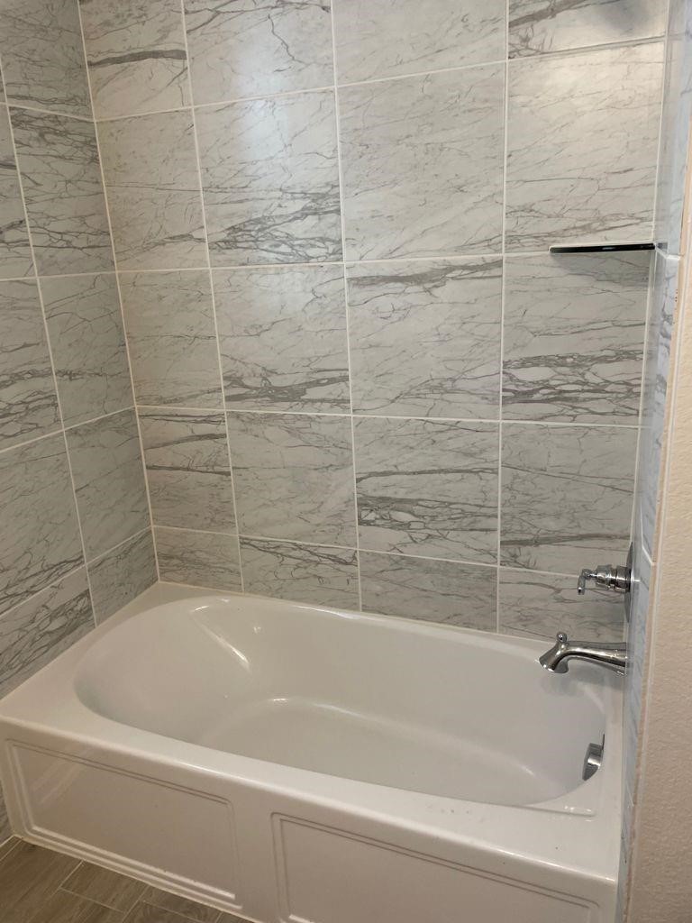 7912 Spring Run North Richland Hills, TX 76182 - Photo 6 of 21 a bathroom with a bathtub and a shower