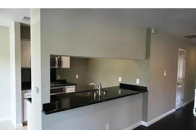 a kitchen with a sink and stainless steel appliances