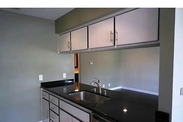 a kitchen with a sink and cabinets