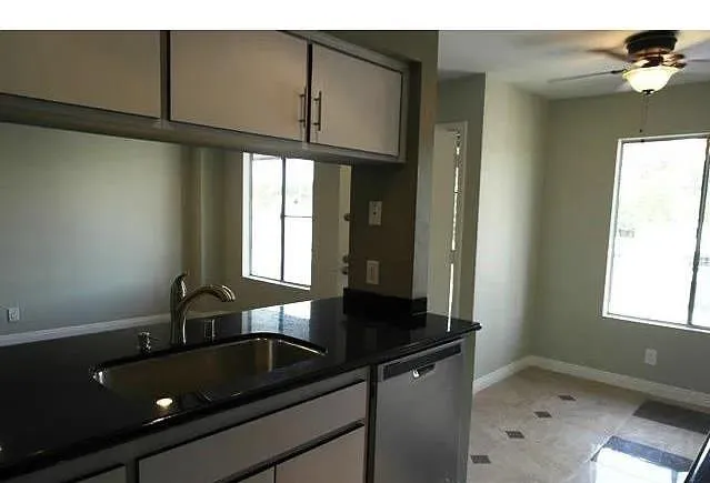 a kitchen with a sink cabinets and window