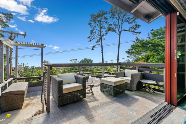 a balcony with furniture and a potted plant