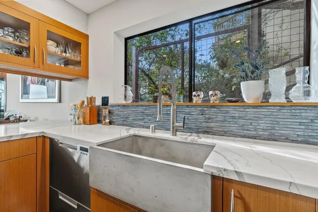a view of a kitchen counter top a sink and a window