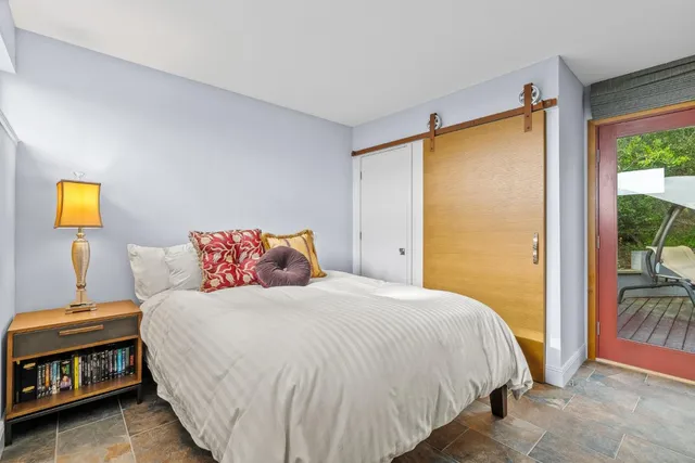 a bedroom with a bed and a window