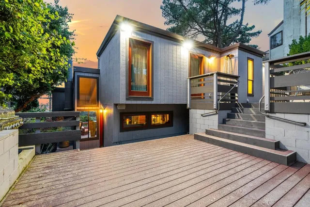 a view of a house with a barbeque and bench